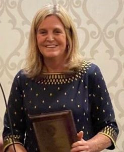 headshot of female holding award