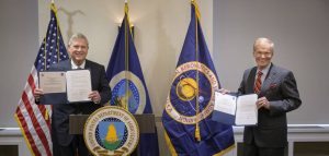U.S. Secretary of Agriculture Thomas Vilsack, left, and NASA Administrator Bill Nelson signing memorandums