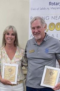 rotary club members holding awards