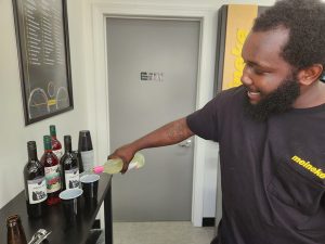 Juwan Wilson pours Layton's Chance Watermelon sweet wine to a guest