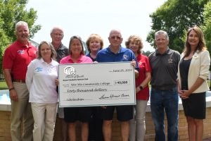 From left, Edward Townsend, Christina Dolomount, Bill Hickey, Kathy Cater, Sharon Sorrentino, Larry Campbell, Cindy Malament and Roger Pacella of the Ocean-City Berlin Optimist Club board of directors present a donation of $40,000 for scholarships to Stefanie K. Rider, executive director of the Wor-Wic Foundation.