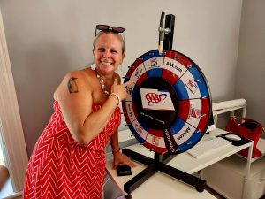 woman smiling standing at AAA spin wheel