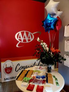 table with balloons flowers giveaways with AAA sign in back