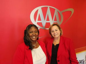 two ladies standing in front of AAA sign