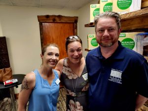 three people standing together at event