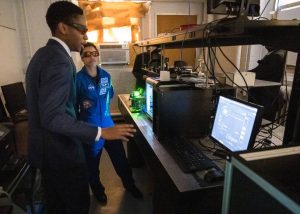 nasa astronaut giving tour to student in lab