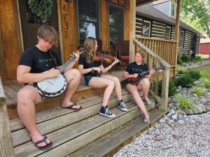 young band members sitting on steps playing instruments