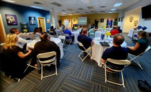 Group of people sitting at tables during a luncheon