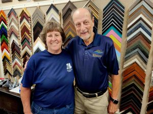 two people standing in front of frame border samples
