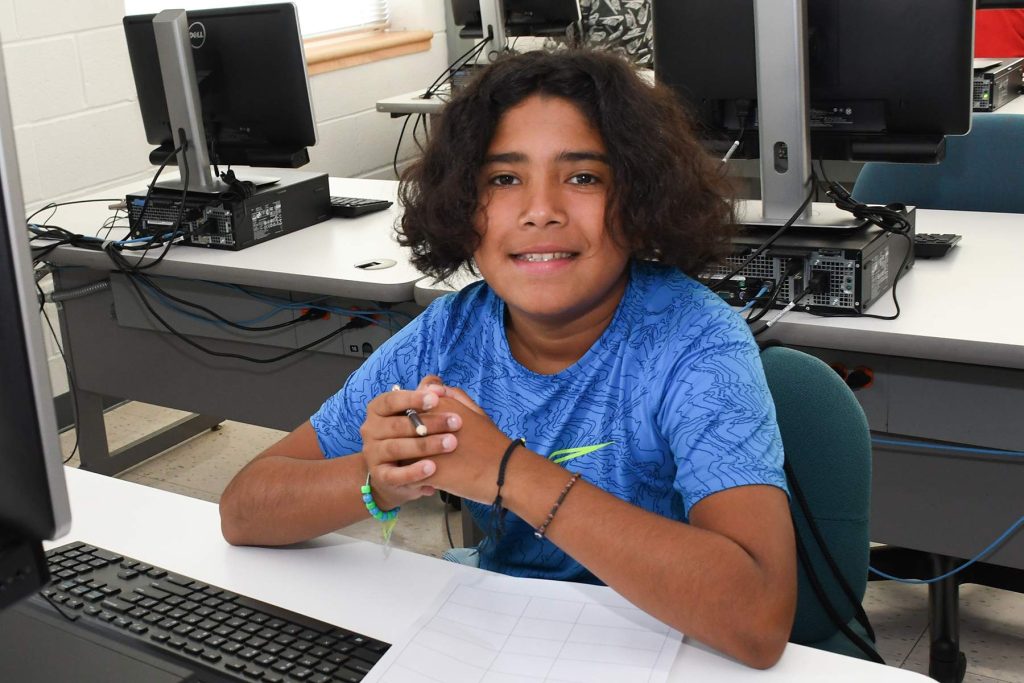 student sitting at computer desk
