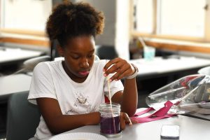 african american student making rock candy