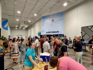 group of people mingling in an auditorium