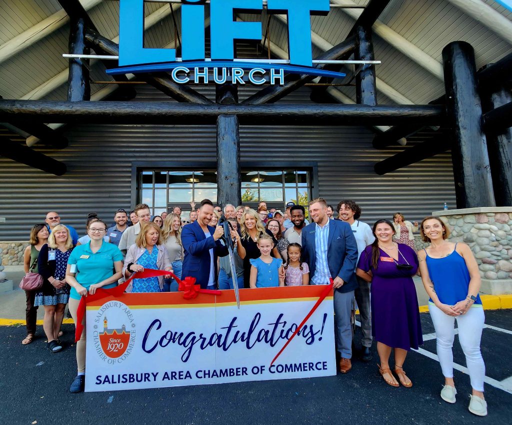 Group of people standing outside Lift Church with a congratulations sign