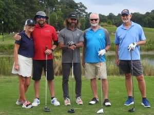 group of golfers standing on green