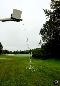 Bucket truck dropping golf balls on the green