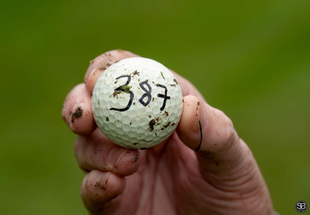 Golf ball with the number 387 written on it
