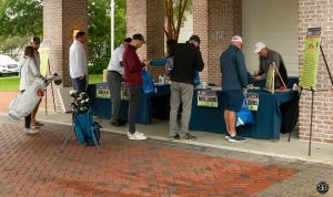 Group of golfers gathered around the registration table