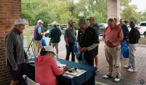 Group of golfers gathered around the registration table