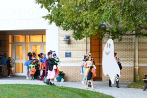 young children walking around a college campus for Halloween candy