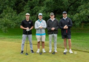 Golf Tournament Foursome of four men standing on a golf course