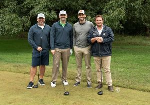 Golf Tournament Foursome of four men standing on a golf course