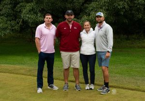 Group of 4 golfers, 3 men and one woman