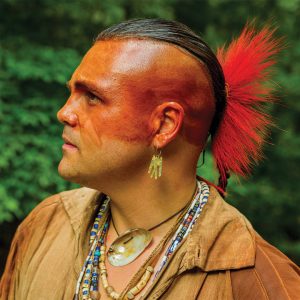 Native American man with a mohawk and tribal face paint