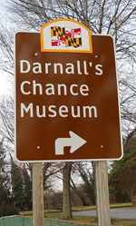 Brown sign from the Maryland Department of Transportation directing raffic to the Darnall's Chance Museum