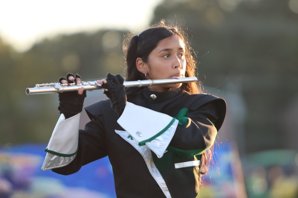 Female high school student playing the flute
