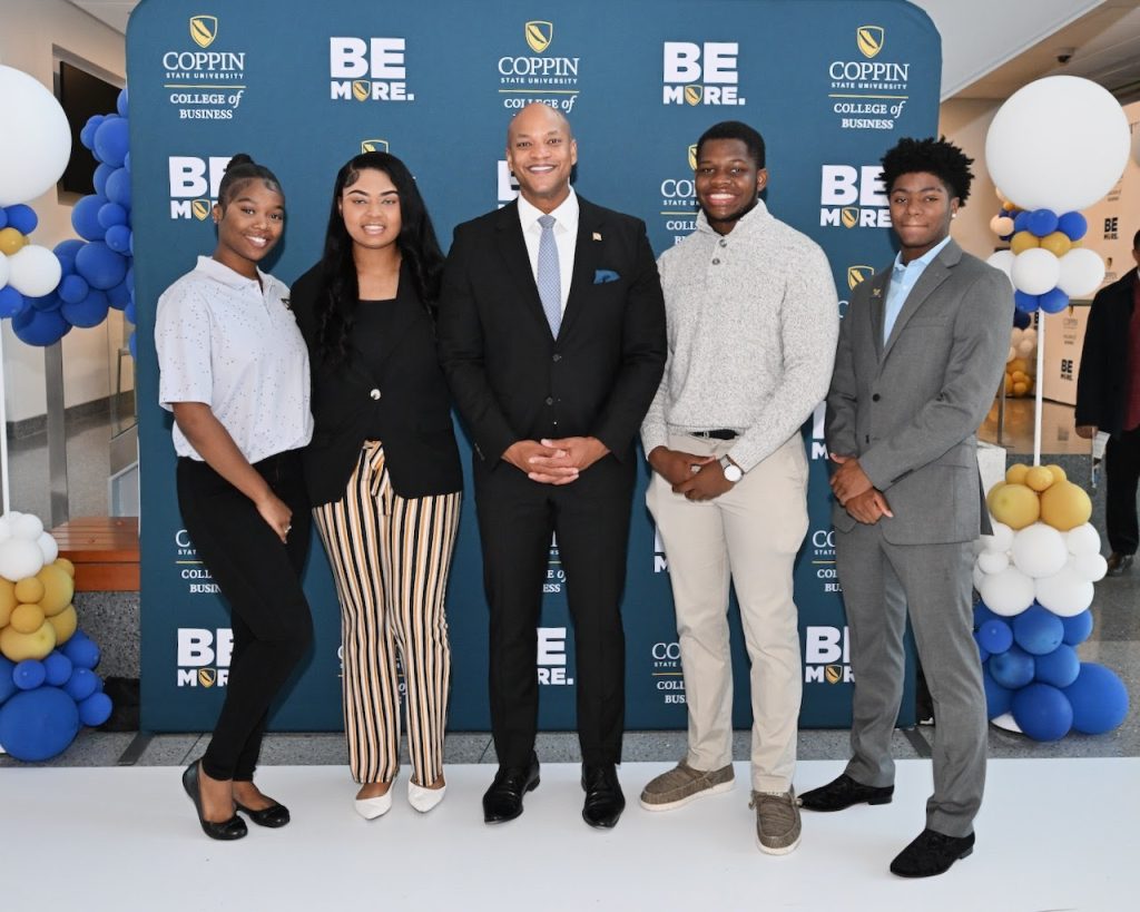 Maryland Governor, Wes Moore, standing with four young adults 
