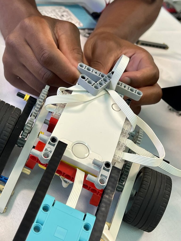space camper building a model rover out of leggos