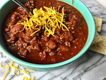 Large bowl of chilli with shredded cheese