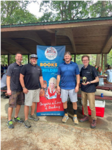 Second place disk golf team holding a trophy