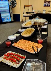 Large black table with several different food options