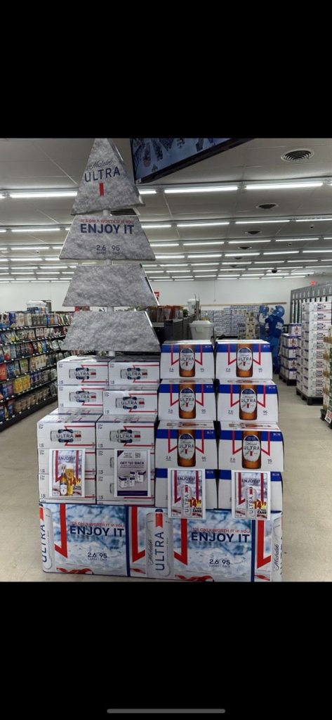 Interior of a liquor store with stacked boxes of beer