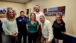 Men and women standing together at an indoor networking event