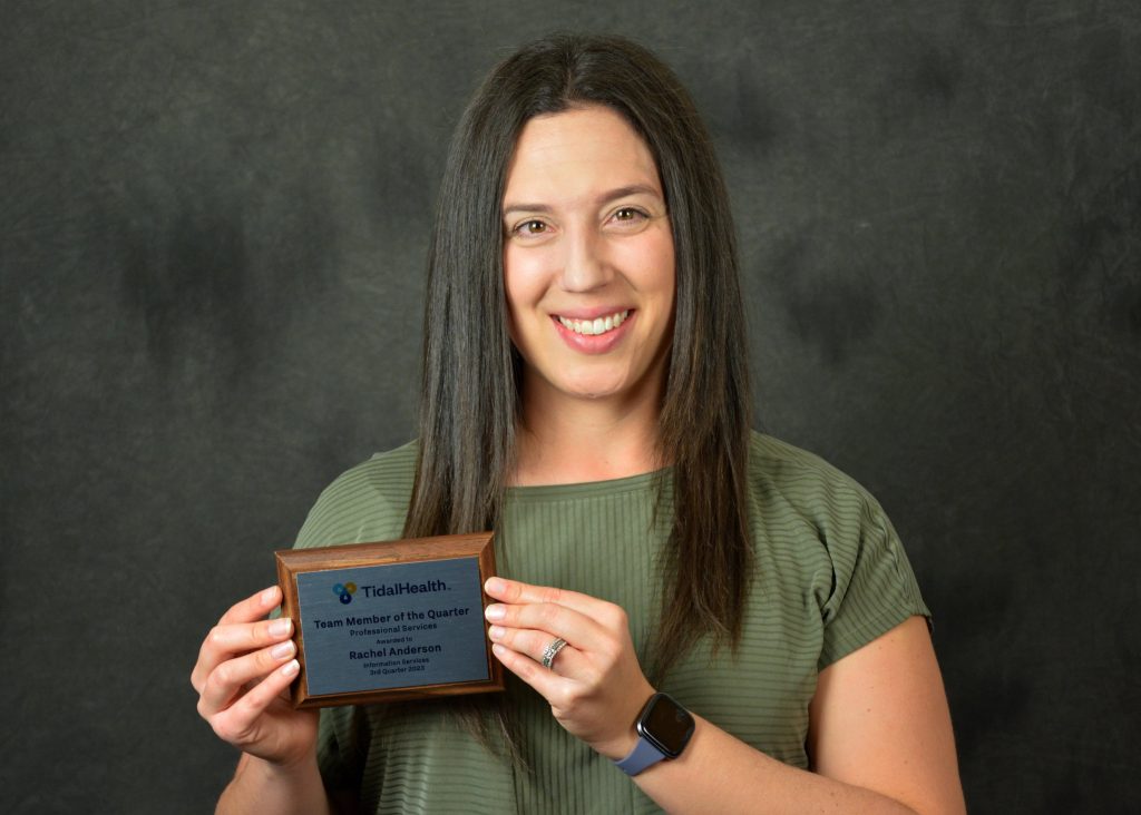 Headshot of Rachel Anderson holding an award