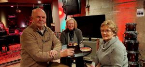 three people having drinks at the AMP Studio Ribbon Cutting