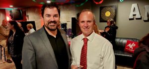 two adult males in business attire for the AMP Studio Ribbon Cutting