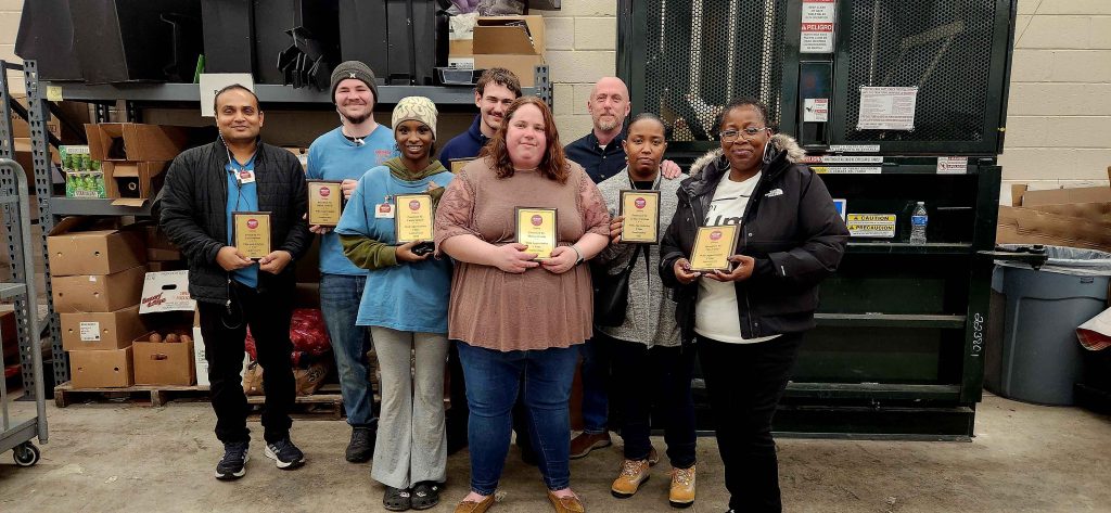 group of people holding awards for the Grocery Outlet