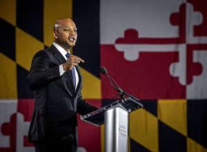Maryland Governor giving a speech beside the Maryland flag