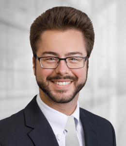 Headshot of Andrew Beatty in a suit