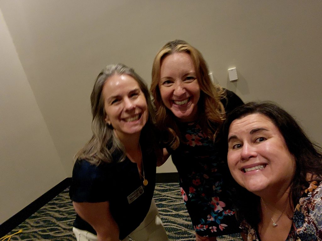 Three women taking a selfie at the Coast Chamber Mixer 2024