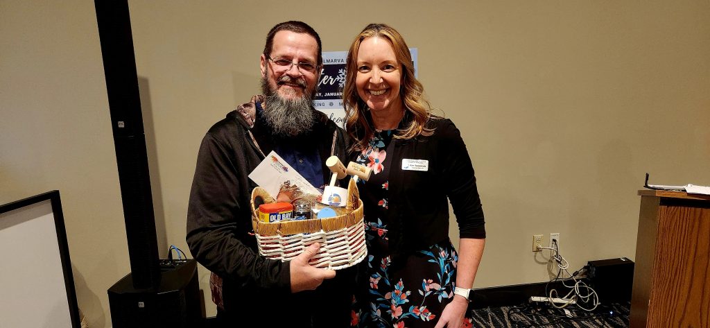 Man and woman holding a gift basket