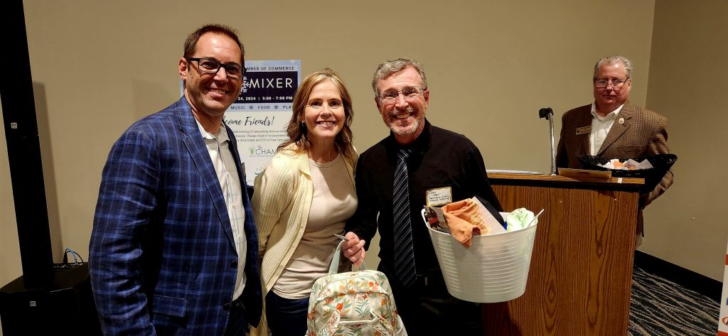People holding gift baskets at the Coast Chamber Mixer 2024