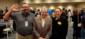 Three people standing together at the Coast Chamber Mixer 2024