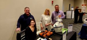 People gathered around a table at the Coast Chamber Mixer 2024