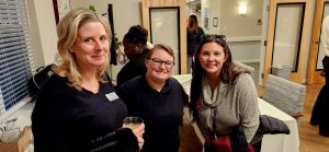 Three young women standing together at an event