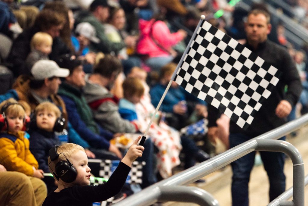 Little boy waving a black and white checkered flag