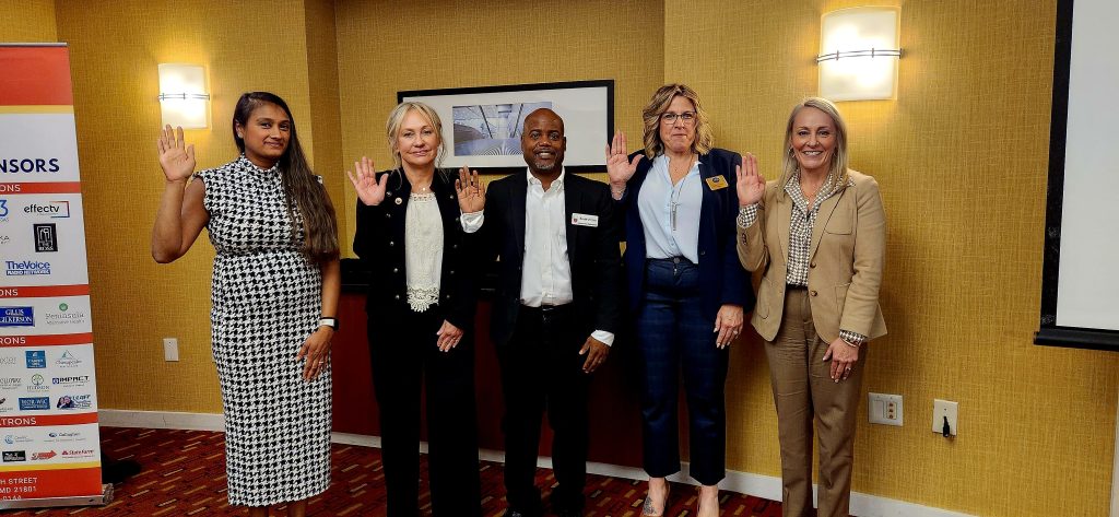 New Board of Directors Members standing with their right hands up
